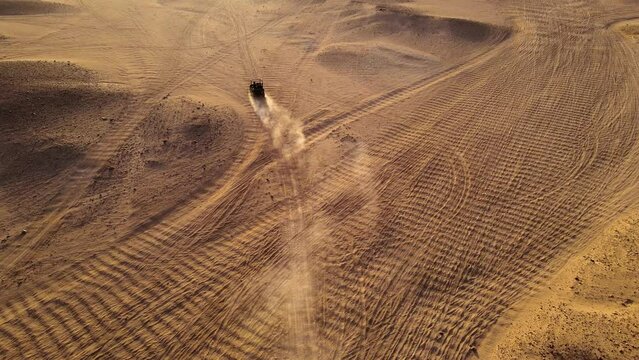 A buggy car drifting in the dunes of an Egyptian desert.
