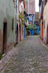 Riquewihr, France. Village established in the 1400's in the Alsace Region. Quaint cobblestone street with medieval homes.