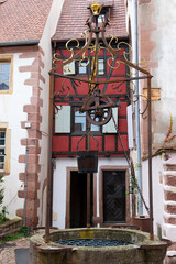 Riquewihr, France. Village established in the 1400's in the Alsace Region. Medieval stone well.