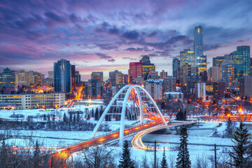 Light trails from rush hour traffic light up Walterdale Bridge in Edmonton, Canada, on a sunset winter night. - 532300630