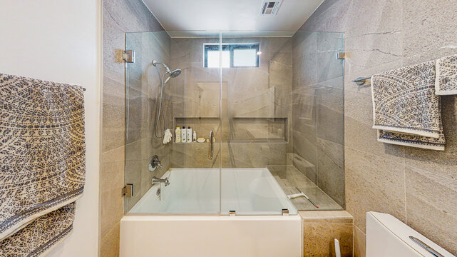 Modern Bathroom With Tub and See Through Glass