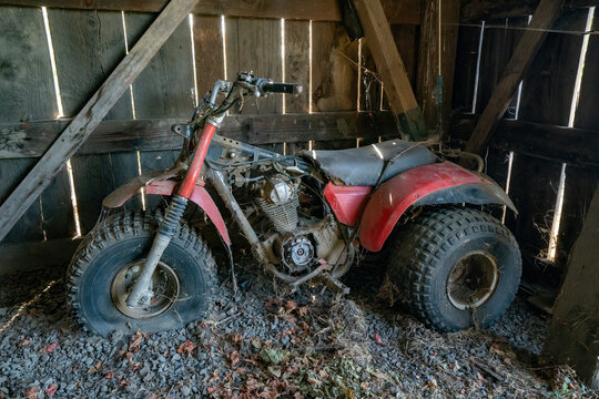 A retired three wheeler in a vintage barn near Salem Oregon