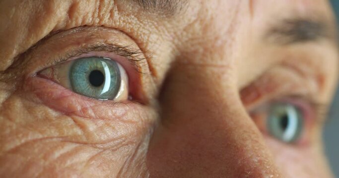 Senior woman, blue eyes and vision in thinking, planning and looking sad in nursing home or house interior. Zoom, texture or face skin of stress, anxiety or mental health burnout in lonely retirement