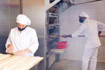 Female baker prepares delicious dough coca bread at bakery. High quality photo