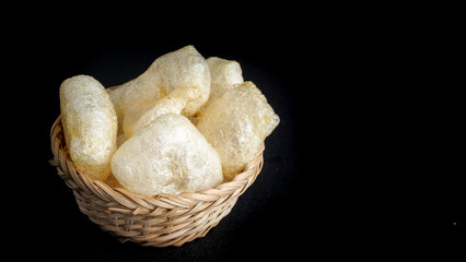 Kerupuk Kulit is a traditional snack from Indonesia on black background