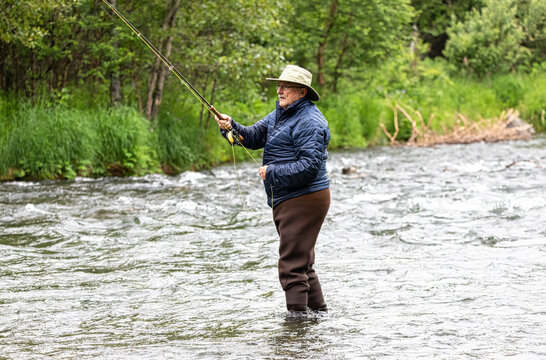 An Older Man Tries His Luck At Fly Fishing For Salmon.  Russian River.  Cooper Landing, Alaska.