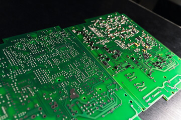 Various stages of SMD surface-mount technology montage. Vivid green PCB printed circuit board as...