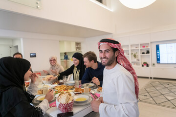 young arabian man having Iftar dinner with muslim family Eating traditional food during Ramadan feasting month at home. The Islamic Halal Eating and Drinking Islamic family