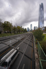 Traffic on highway in front of Costanera center in Santiago, Chile during stormy winter day 