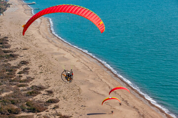 Paramotor pilots flying over beach in Belek, Antalya, Turkey.