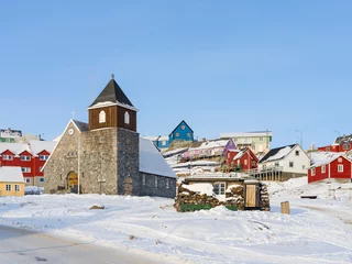 Fotobehang The church. Town Uummannaq during winter in northern West Greenland beyond the Arctic Circle. Greenland, Danish territory © Danita Delimont
