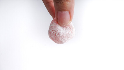 Mochi, Japanese Dessert hold by hands. In Indonesia Popular as Moaci or Mochi Sukabumi.