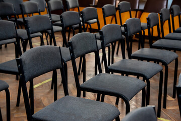 a lot of black chairs for the whole frame, places for spectators