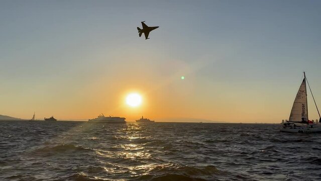 sunset over the sea and F16 jet