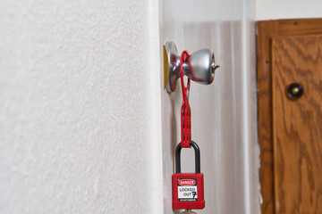 lock attached to lockout/tagout fixed to doorknob
