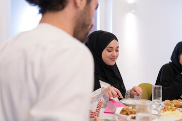 Muslim family making iftar dua to break fasting during Ramadan.