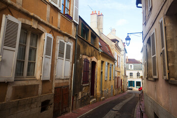 View of old narrow streets of French city of Auxerre in autumn day..