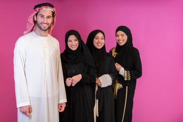 Group portrait of young Muslim people Arabian men with three Muslim women in a fashionable dress...