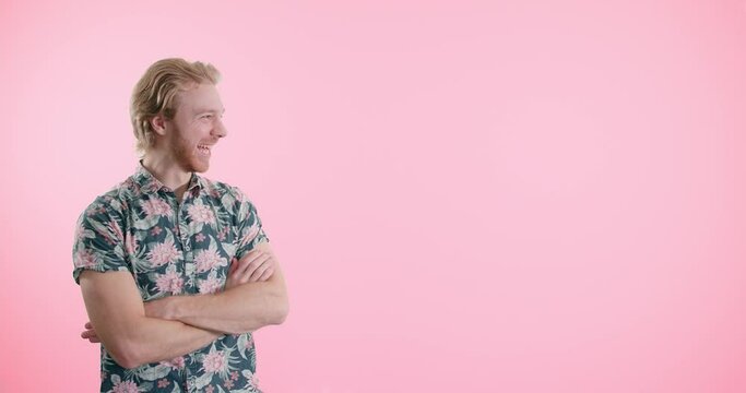 Young Man Reaction Pointing Cheering Happy Excited in front of Pink Background Copy-Space with Room for Text Logo Graphic Message 