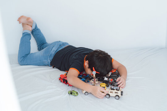 Child playing Boy plays with toy cars