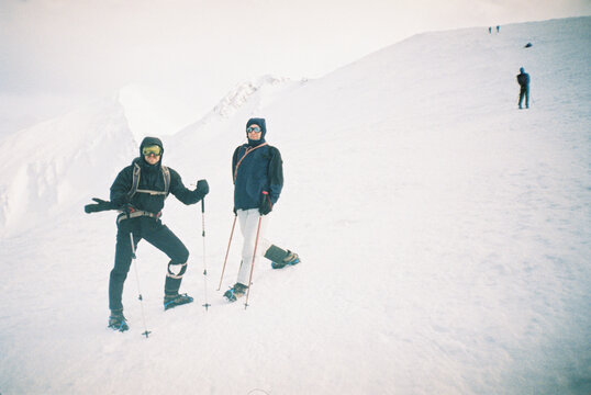 Hikers Exploring Mountains In Blizzard