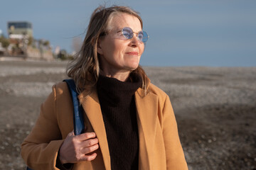 Middle aged female looking away on beach