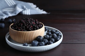 Freeze dried and fresh blueberries on wooden table. Space for text