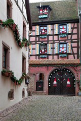 Riquewihr, France. Village established in the 1400's in the Alsace Region. Quaint cobblestone street with medieval homes.