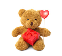 Cute teddy bear with red heart and gift box on white background. Valentine's day celebration