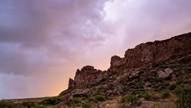Sunset timelapse as rain lands on lens looking at rocky cliffs in the Flaming Gorge Recreation area.
