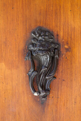 Italy, Tuscany. Ornate door knocker in the historic hill town of Montalcino.