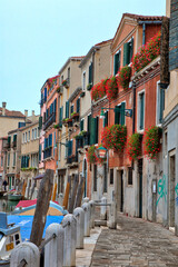 Fototapeta na wymiar Italy, Venice. Street along the canal in Venice.