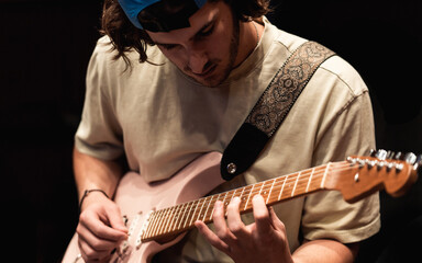 Man Playing Electric Guitar in Recording Studio