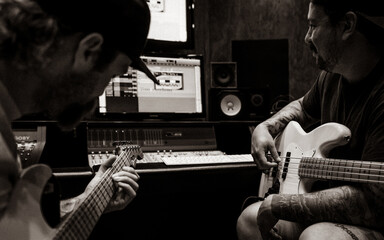 Veteran Friends Playing Guitar and Bass in Recording Studio