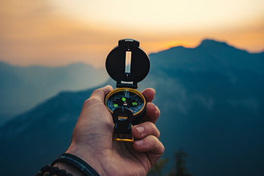 Hand Holding Compass Outdoors