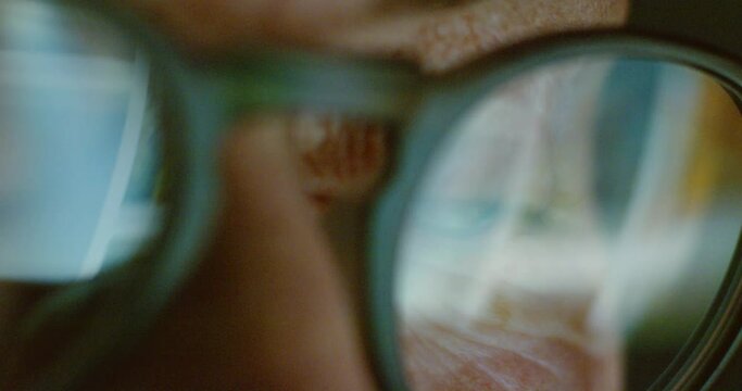 Eyes, vision and man search internet, web or social media app with eye glass mirror reflection. Night, info and cyber stalker or hacker scroll through virtual network profile of an online media user