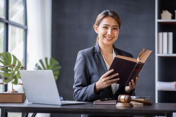 Attractive lawyer in office Business woman and lawyers discussing contract papers with brass scale...