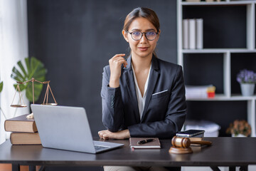 Attractive lawyer in office Business woman and lawyers discussing contract papers with brass scale...
