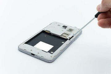 The situation of repairing a cell phone using a screwdriver tool