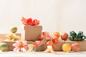 Christmas gift box and ball ornament on white paper background
