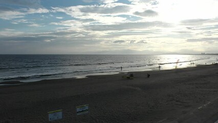FUJISAWA, KANAGAWA, JAPAN - AUGUST 2022 : View of Enoshima beach (sea) at Shonan area in sunset. Romantic, moody sky in dusk. Japanese hot summer holiday (vacation) season concept video.