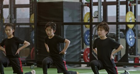 Active children having exercise class with their coach in gym,4K