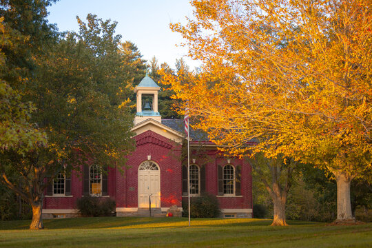 Front exterior of old traditional red brick schoolhouse during autumn in Cincinnati Ohio horizontal