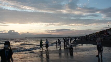 FUJISAWA, KANAGAWA, JAPAN - AUGUST 2022 : View of Enoshima beach (sea) at Shonan area in sunset. Time lapse shot, dusk to night. Japanese hot summer holiday (vacation) season concept video.