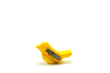 Unique used yellow pencil sharpener in the shape of a bird isolated on white