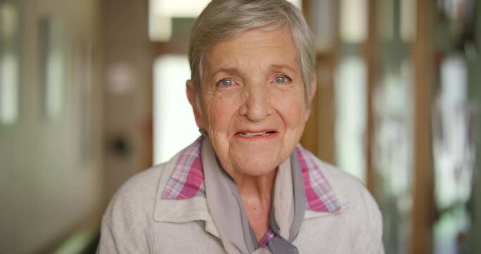 Portrait Of A Happy Elderly Woman In The Retirement Home Lobby With A Positive Mindset. Happiness, Peaceful And Calm Face Of A Senior Pensioner With A Smile Standing Inside Her Vintage House Alone.