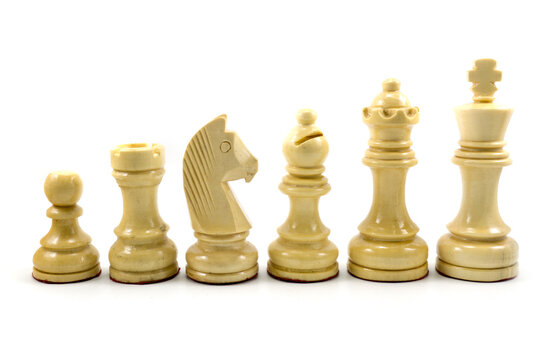 White chess pieces made of wood in descending order isolated on white