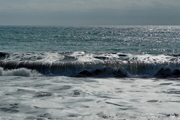 Wave breaking on Los Frailes beach in Machalilla National Park outside of Puerto Lopez, Ecuador