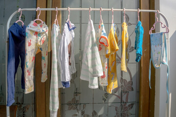 Drying baby clothes by hanging in front of the house