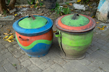 Two colorful trash cans from used car rubber tires.